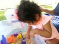 Arielle feeling and exploring the sand.